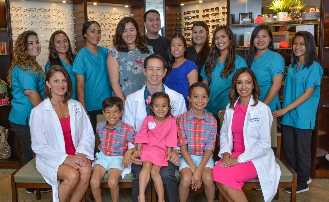 Staff and eye doctors smiling in group photo at best eye clinic in Hawaii